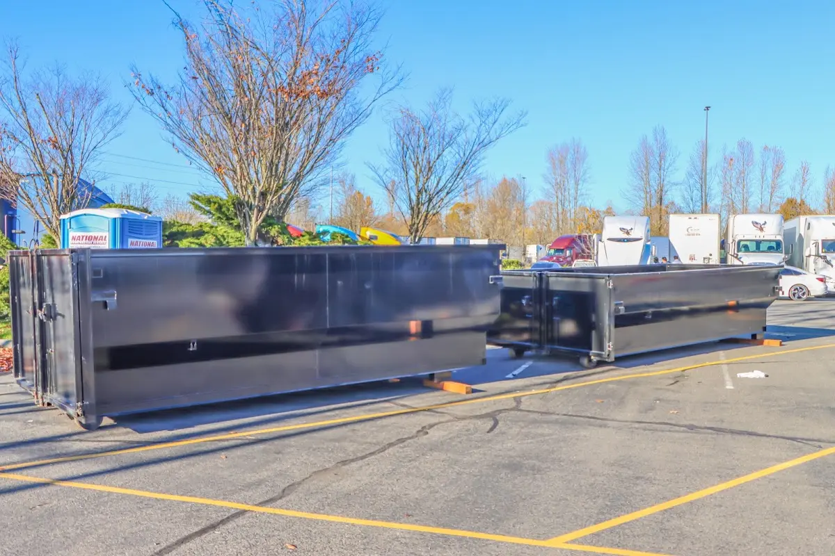 Professional dumpster rental service with roll-off container on residential driveway in Five Forks